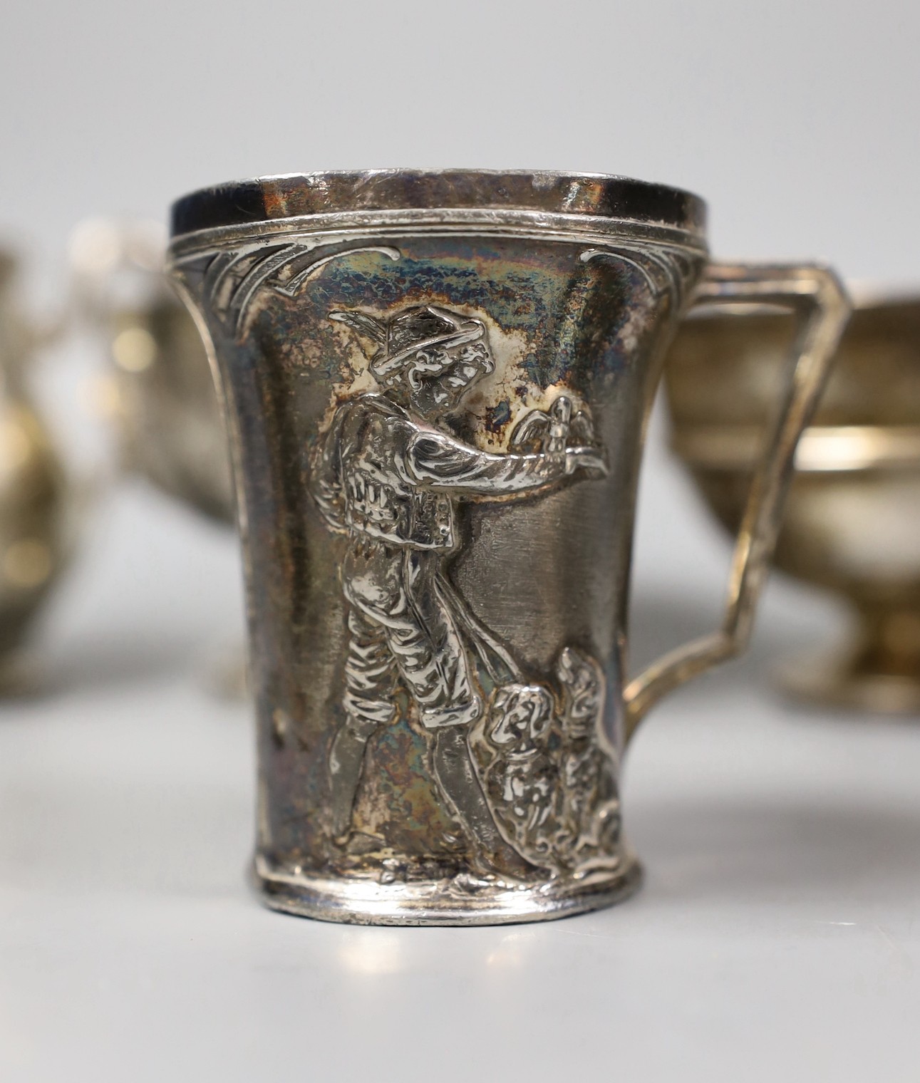 Mixed silver and white metal items including par of toastracks, sugar bowl match sleeve, sauceboat, cream jug, Victorian christening mug, pair of silver mounted clothes brushes, silver mustard silver cigarette case, 25.8